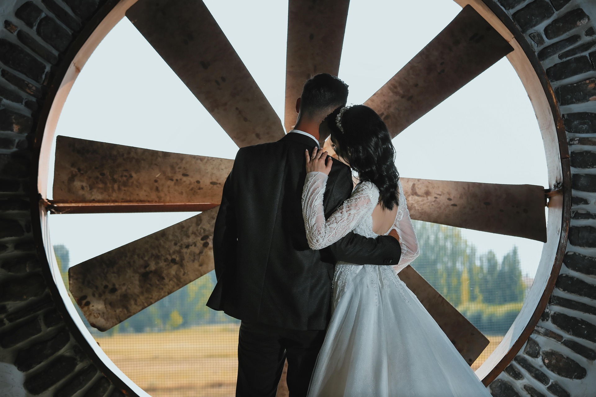 A couple looking out a farm window.
