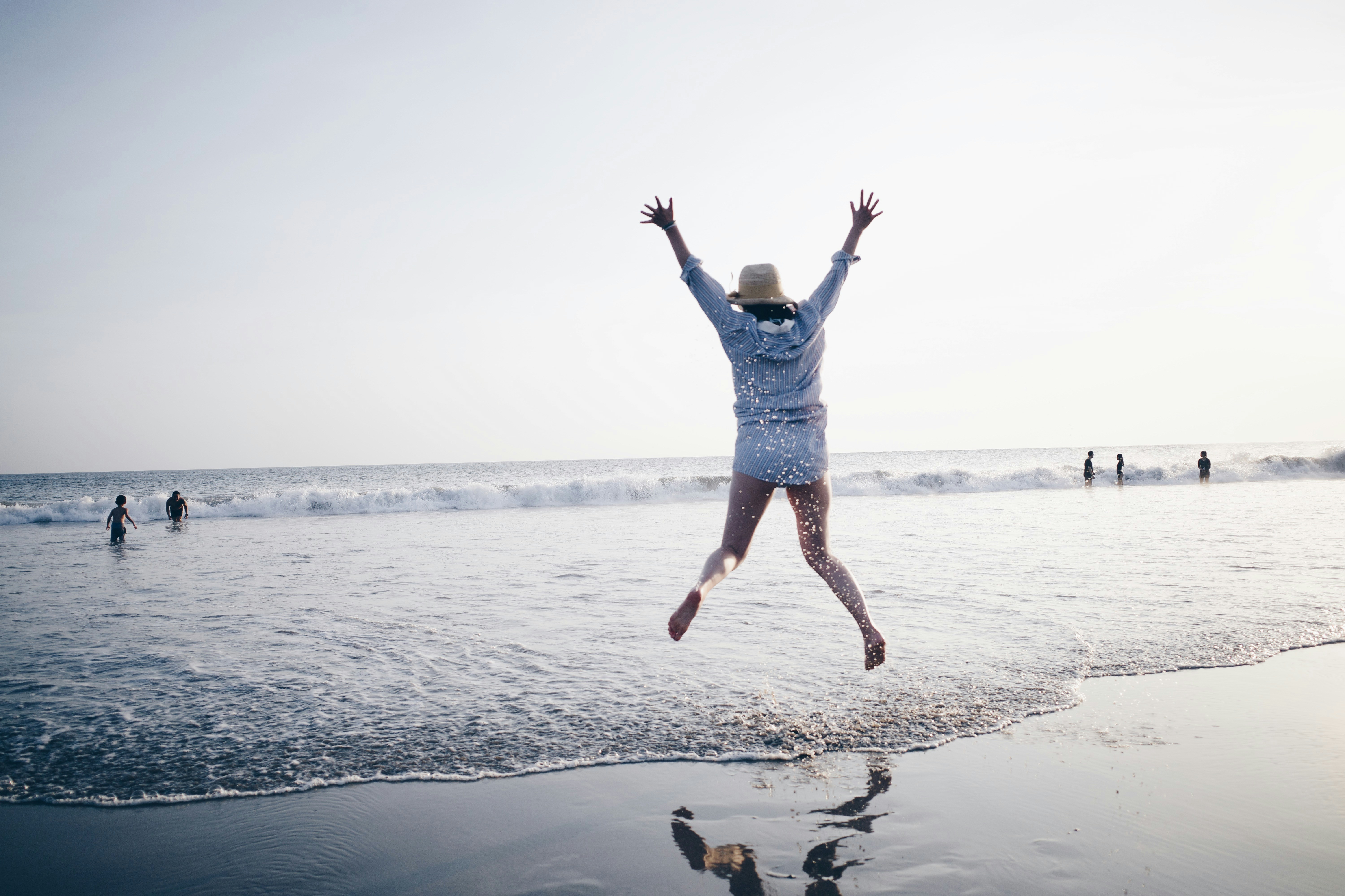 Retiree jumping in the waves.